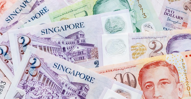 Pile of mixed denomination Singapore Dollar banknotes
