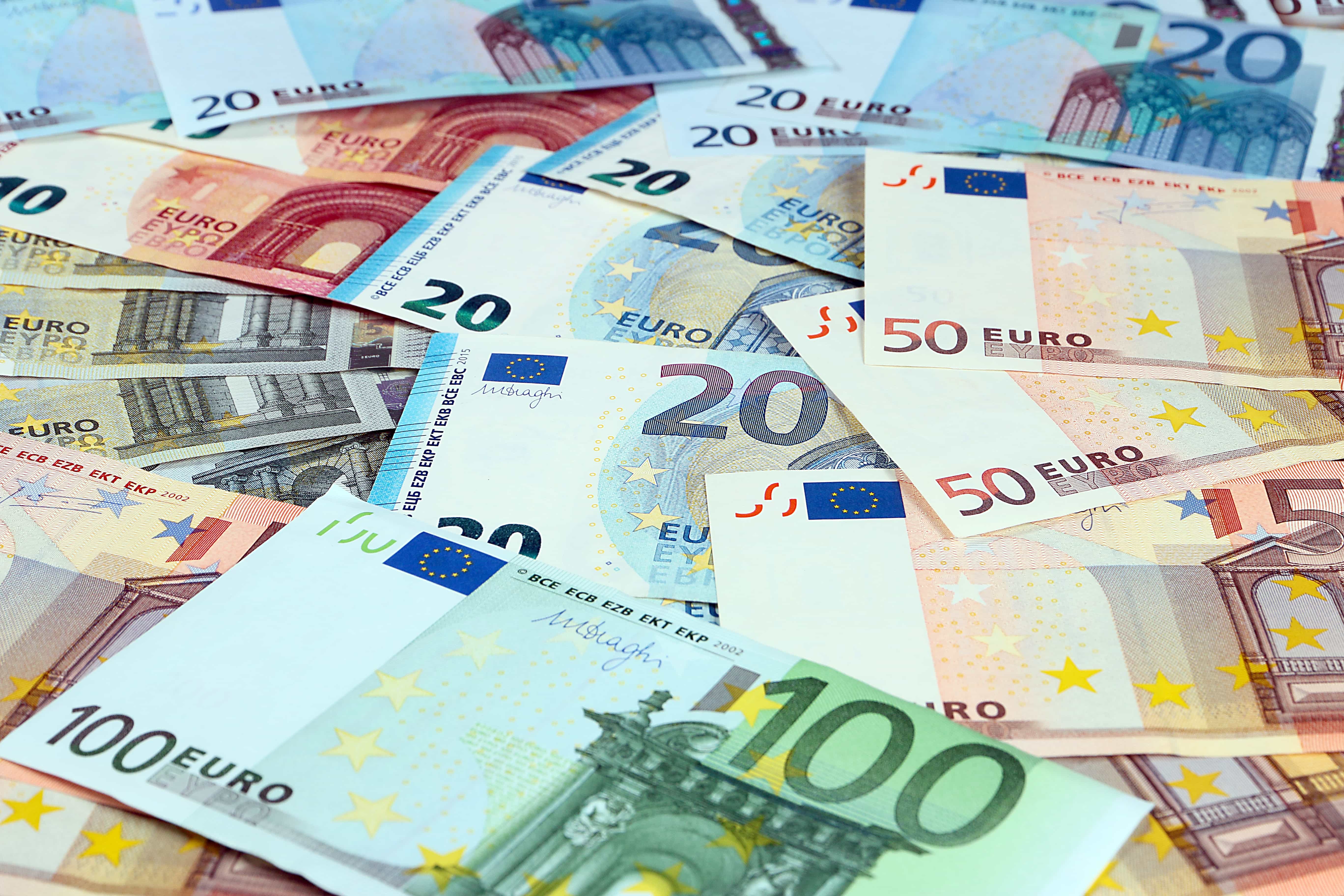 Pile of mixed denomination euro banknotes available at travel money bureaux