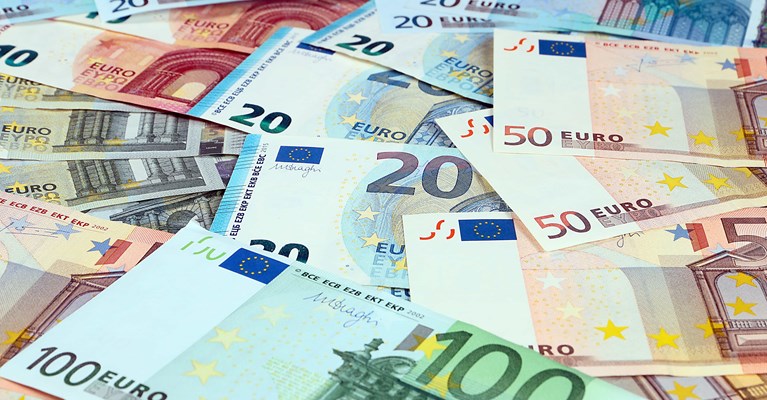 Pile of mixed denomination euro banknotes available at travel money bureaux