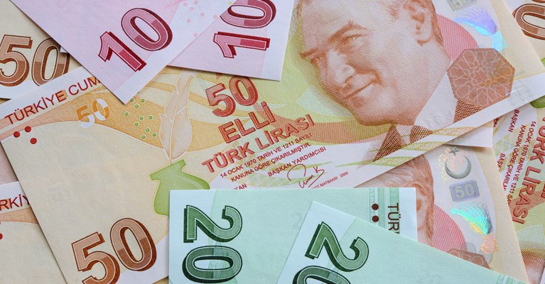 Pile of mixed denomination Turkish Lira banknotes available at travel money bureaux