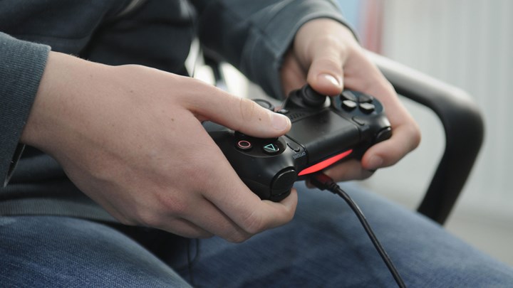 hands on a playstation controller
