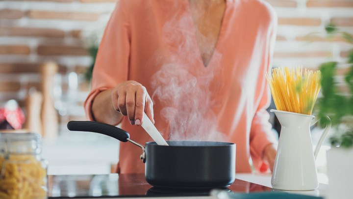 woman cooking spaghetti