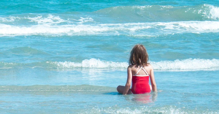 a child sat on the seashore