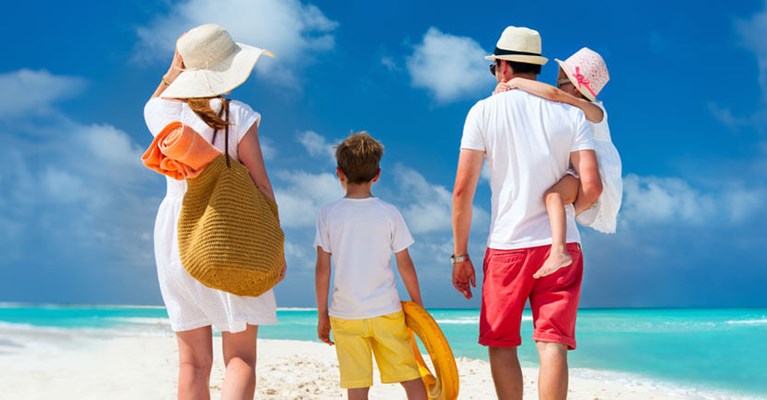 family standing on a beach