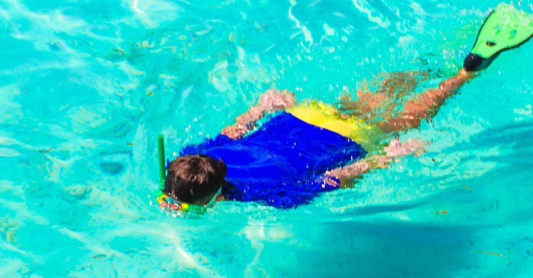 Woman snorkelling in blue water
