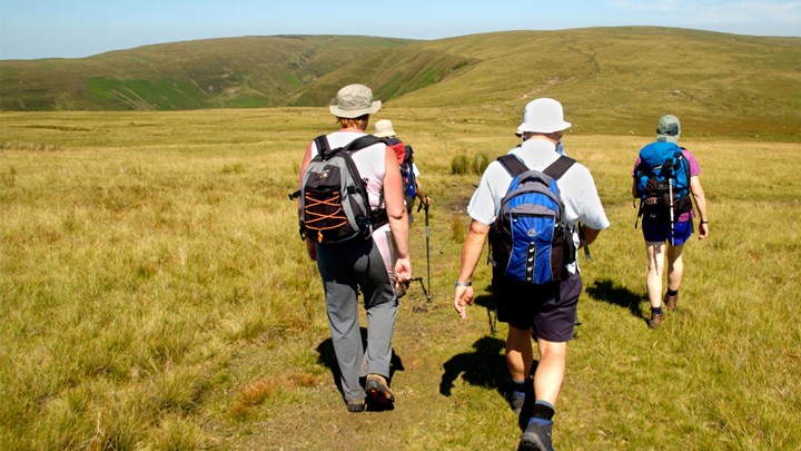 group of people out walking across hills