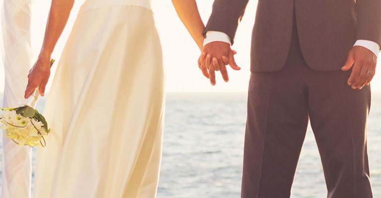 A bride and groom holding hands