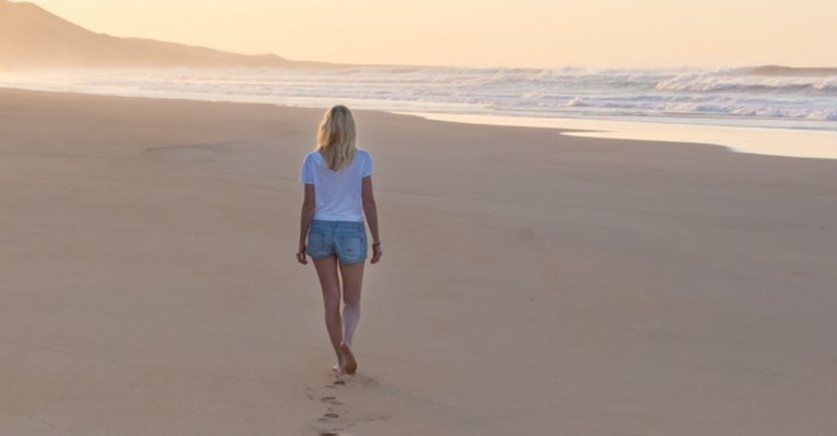 A woman walking on a beach