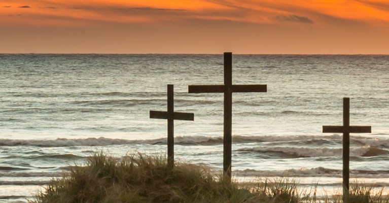 Christian grave markers near a beach