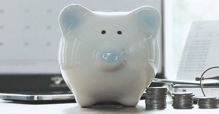 Piggybank next to coins