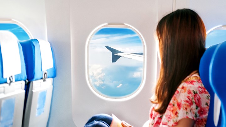 woman looking out an aeroplane window