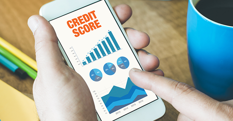 Hands using a phone to look at a credit score