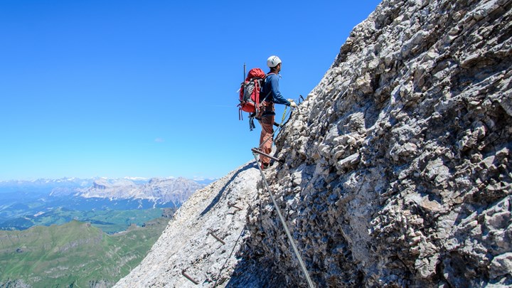 man climbing dolomites