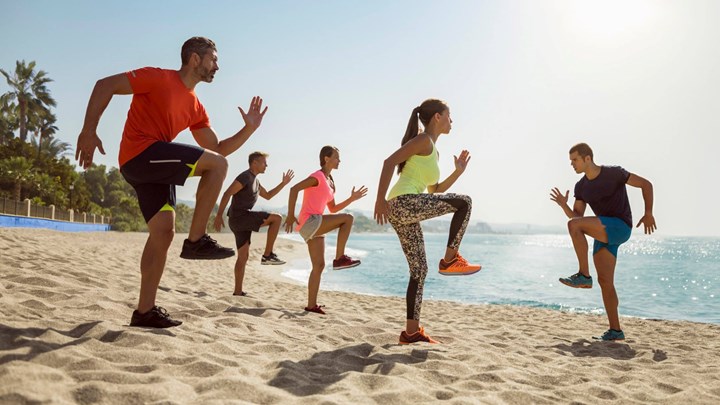 people exercising on the beach