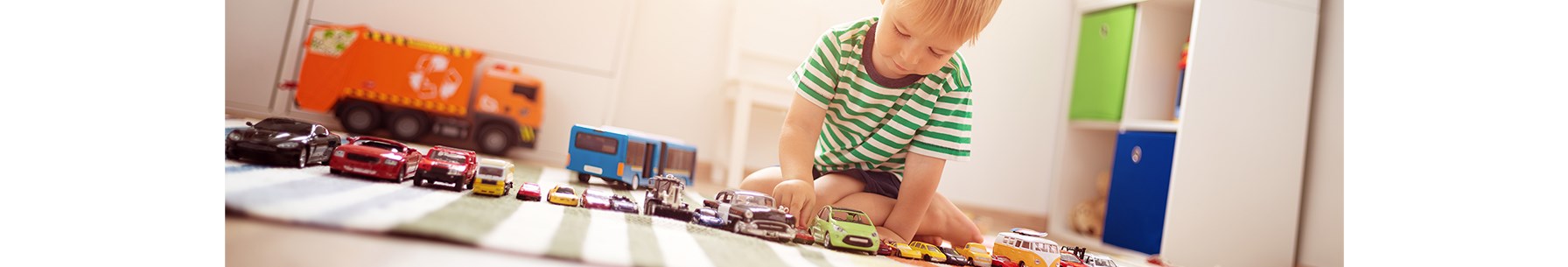 child playing with toy cars