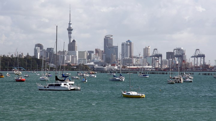 boats on the water in front of a city skyline