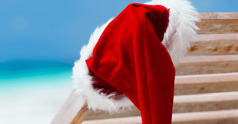 Santa hat on a chair at the beach