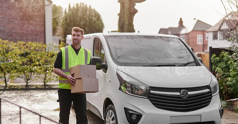 Man delivering parcel from delivery van