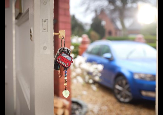 A set of keys are left in a door lock