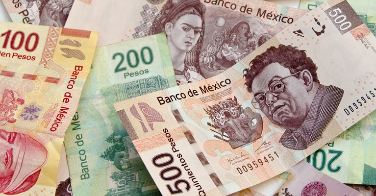 Pile of mixed denomination Mexican Peso banknotes