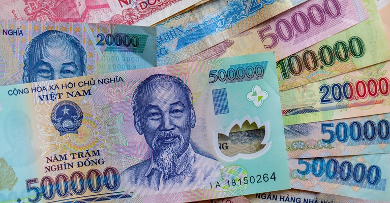 Pile of mixed denomination Vietnamese Dong banknotes