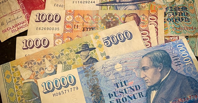 Pile of mixed denomination Icelandic Krona banknotes